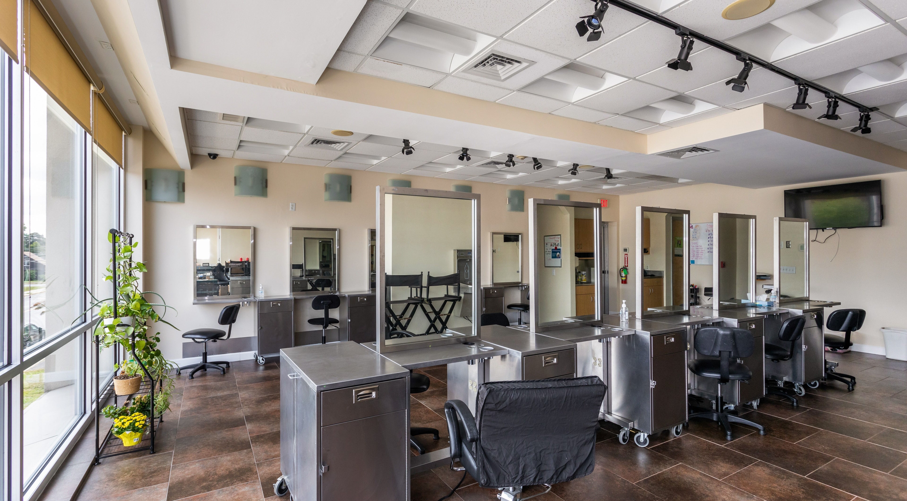 Modern salon interior at IIC Plainville, Plainville, Connecticut, US with styling stations and natural light.