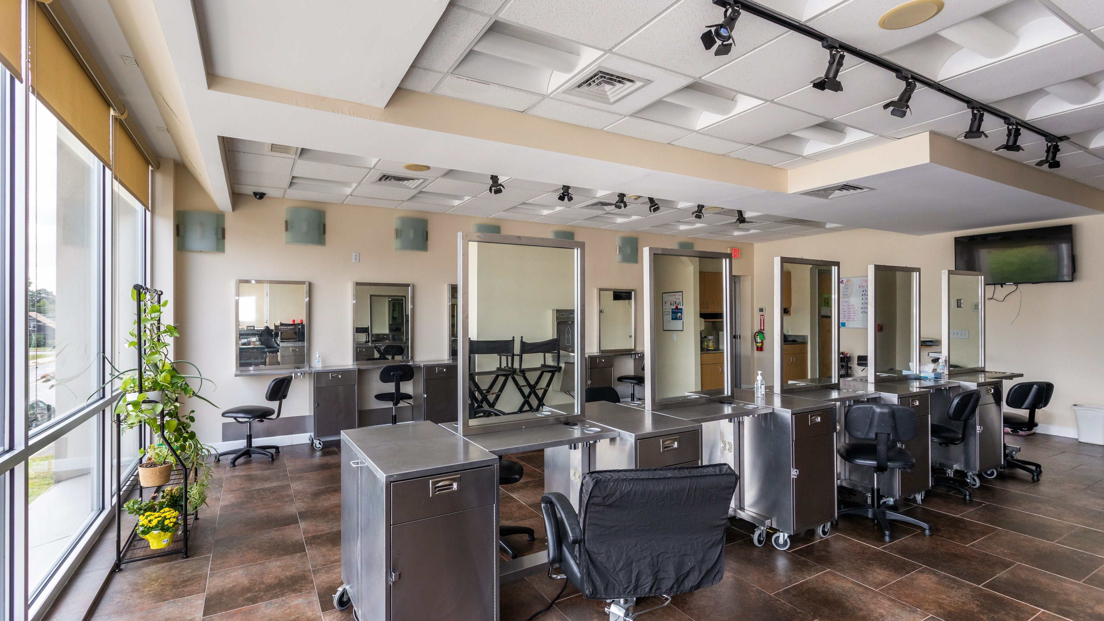 Modern salon interior at IIC Plainville, Plainville, Connecticut, US with styling stations and natural light.