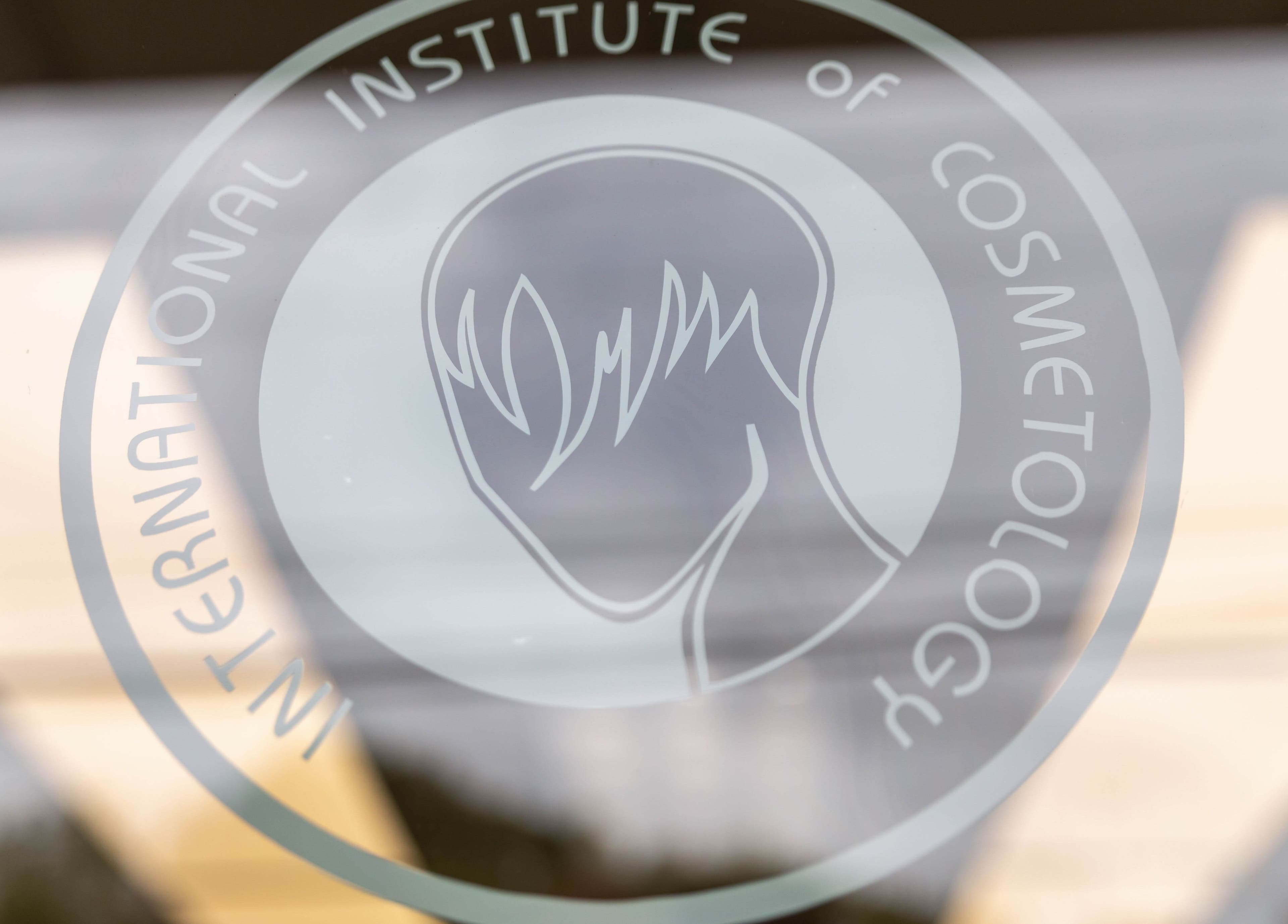 Logo of IIC Wethersfield, a beauty school in Wethersfield, Connecticut, US, displayed on a glass door.
