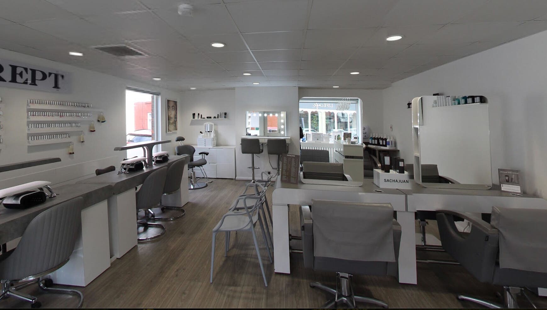 Modern interior of Prept Romiley salon, Romiley, England, GB, featuring stylish workstations and a welcoming ambiance.