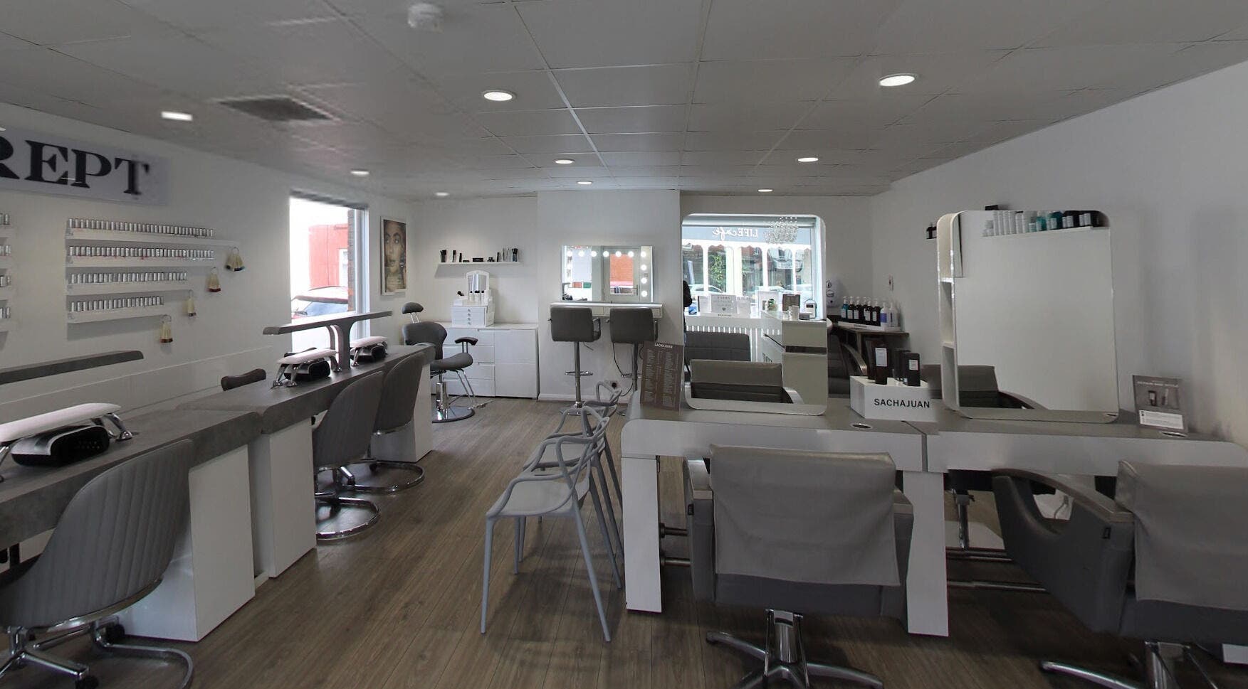 Modern interior of Prept Romiley salon, Romiley, England, GB, featuring stylish workstations and a welcoming ambiance.