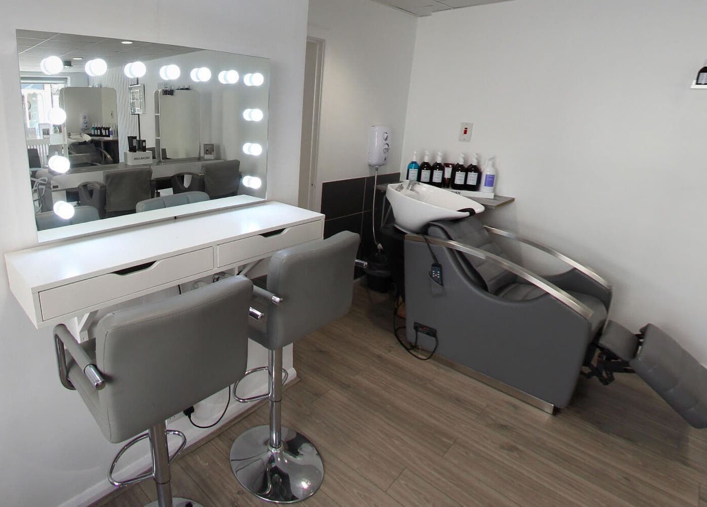Elegant salon interior at Prept Romiley with modern styling chairs and illuminated mirror in Romiley, England, GB.