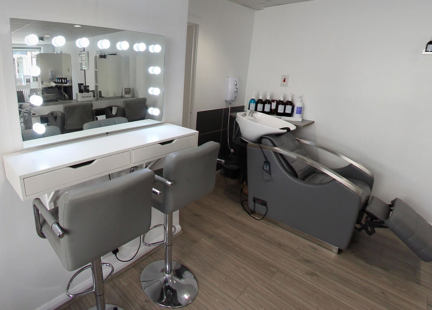 Elegant salon interior at Prept Romiley with modern styling chairs and illuminated mirror in Romiley, England, GB.