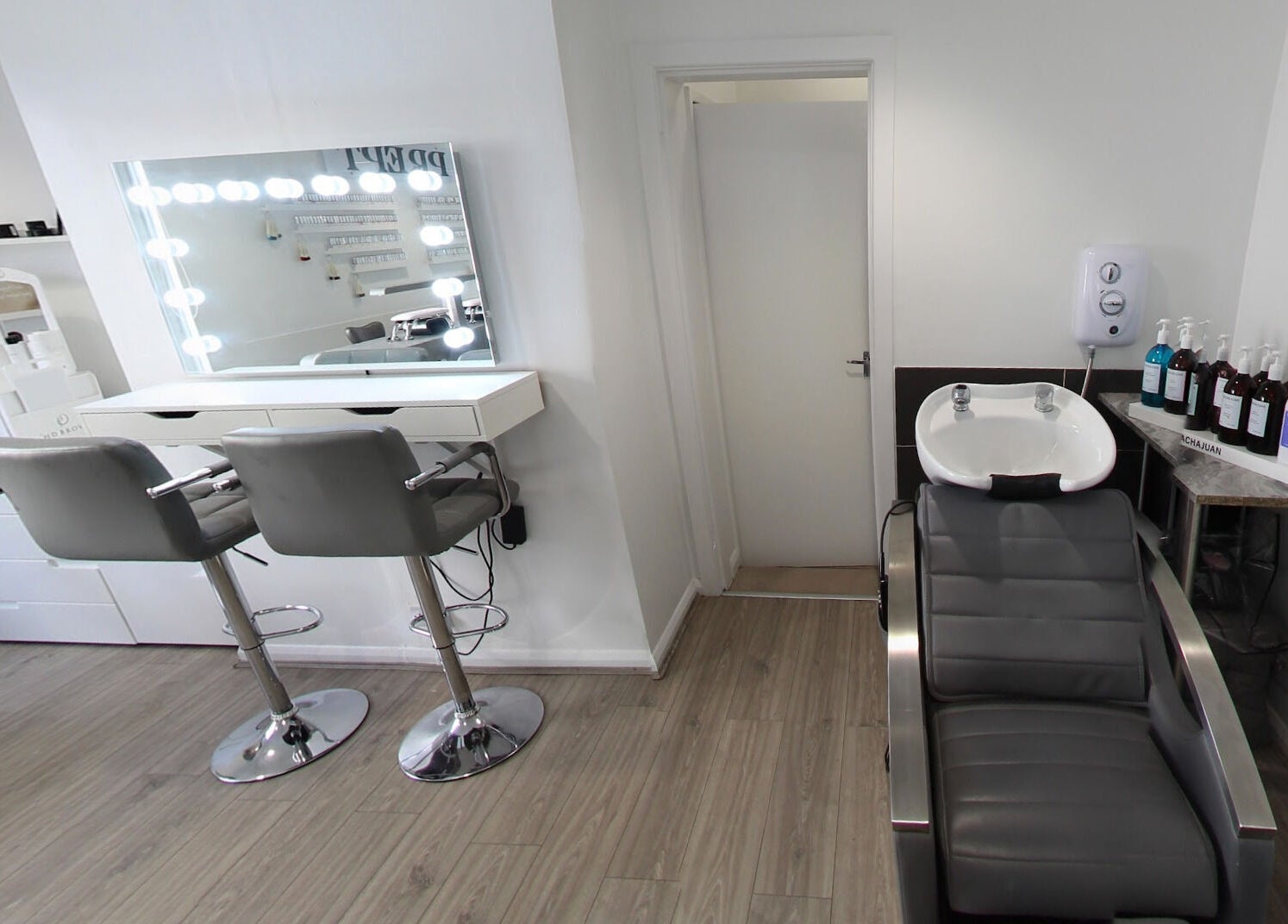 Modern salon interior at Prept Romiley featuring styling chairs and wash basin, Romiley, England, GB.