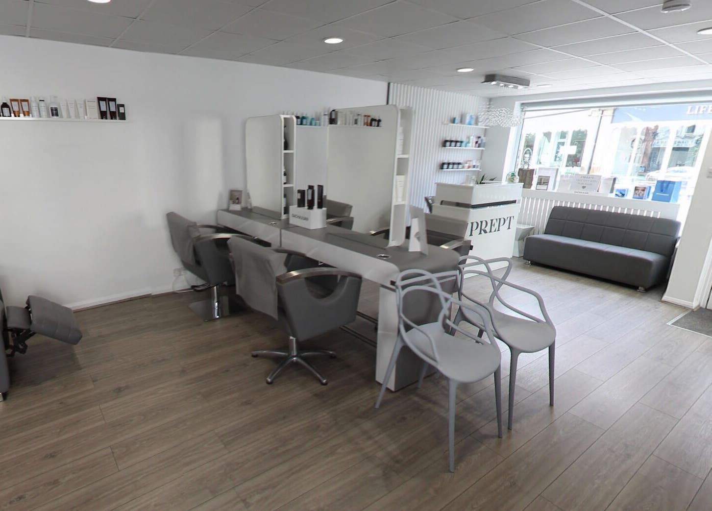 Modern and chic interior of Prept Romiley, Romiley, England, GB, showcasing sleek salon stations and elegant decor.
