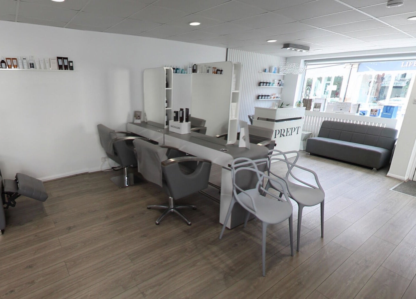 Modern and chic interior of Prept Romiley, Romiley, England, GB, showcasing sleek salon stations and elegant decor.