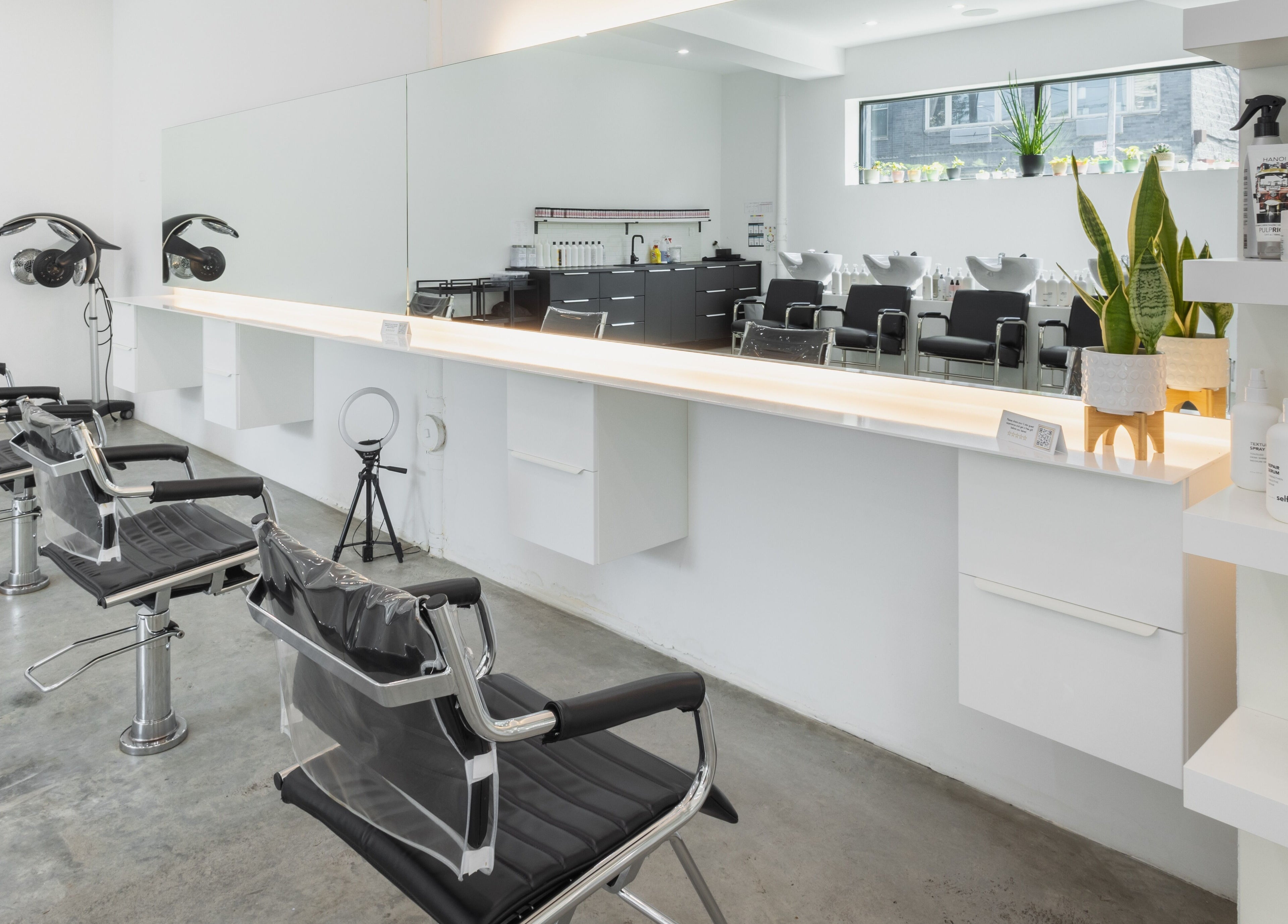Modern salon interior at Self Bushwick, New York, New York, US with sleek chairs and mirrors.