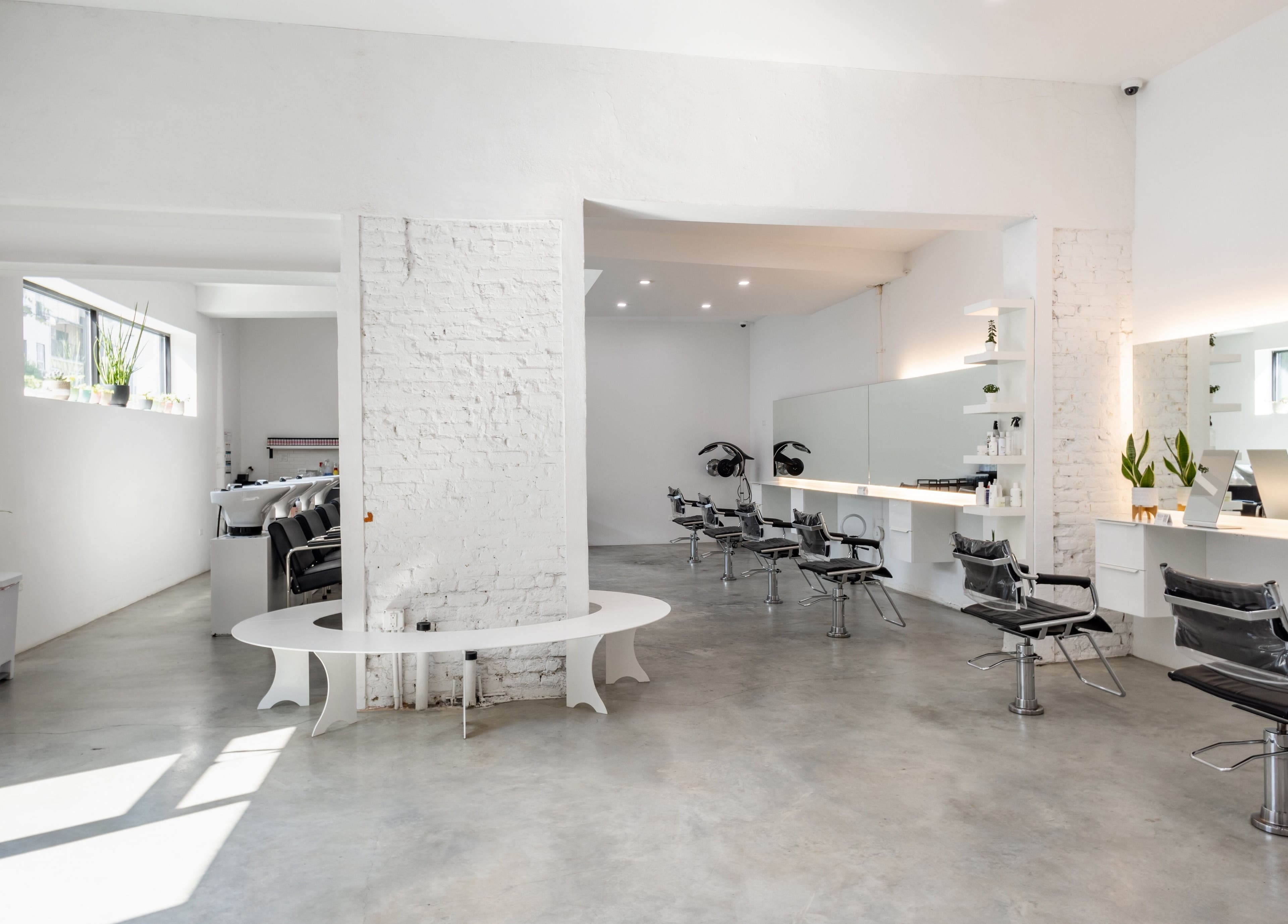 Modern salon chairs and mirrors at Self Bushwick, New York, New York, US, with sleek decor and natural light.
