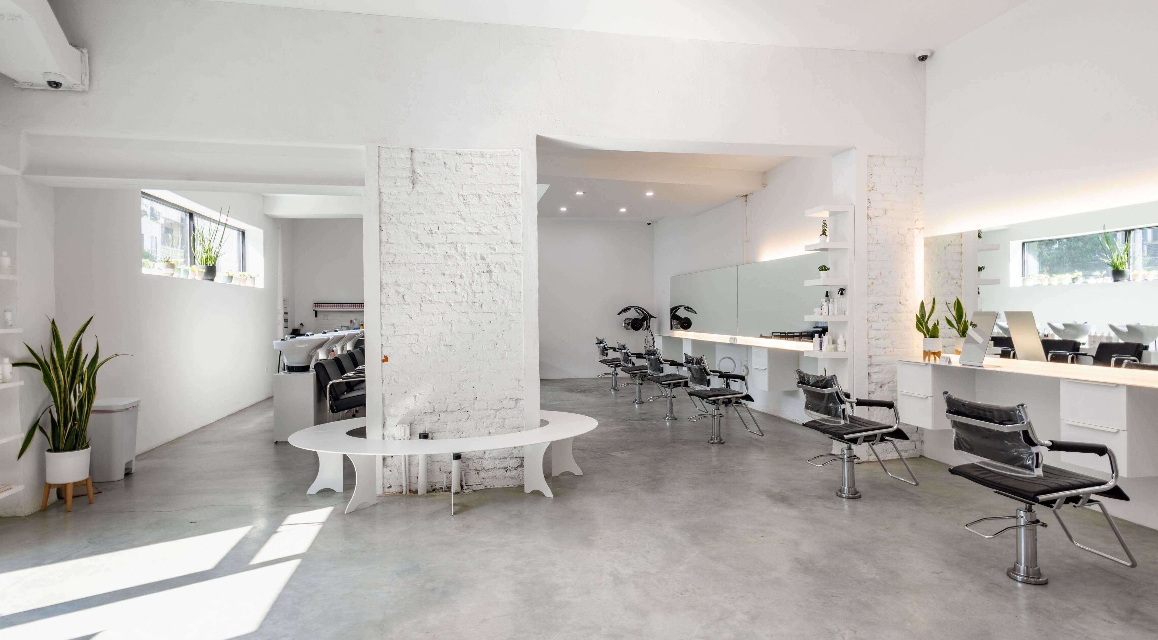 Modern salon chairs and mirrors at Self Bushwick, New York, New York, US, with sleek decor and natural light.