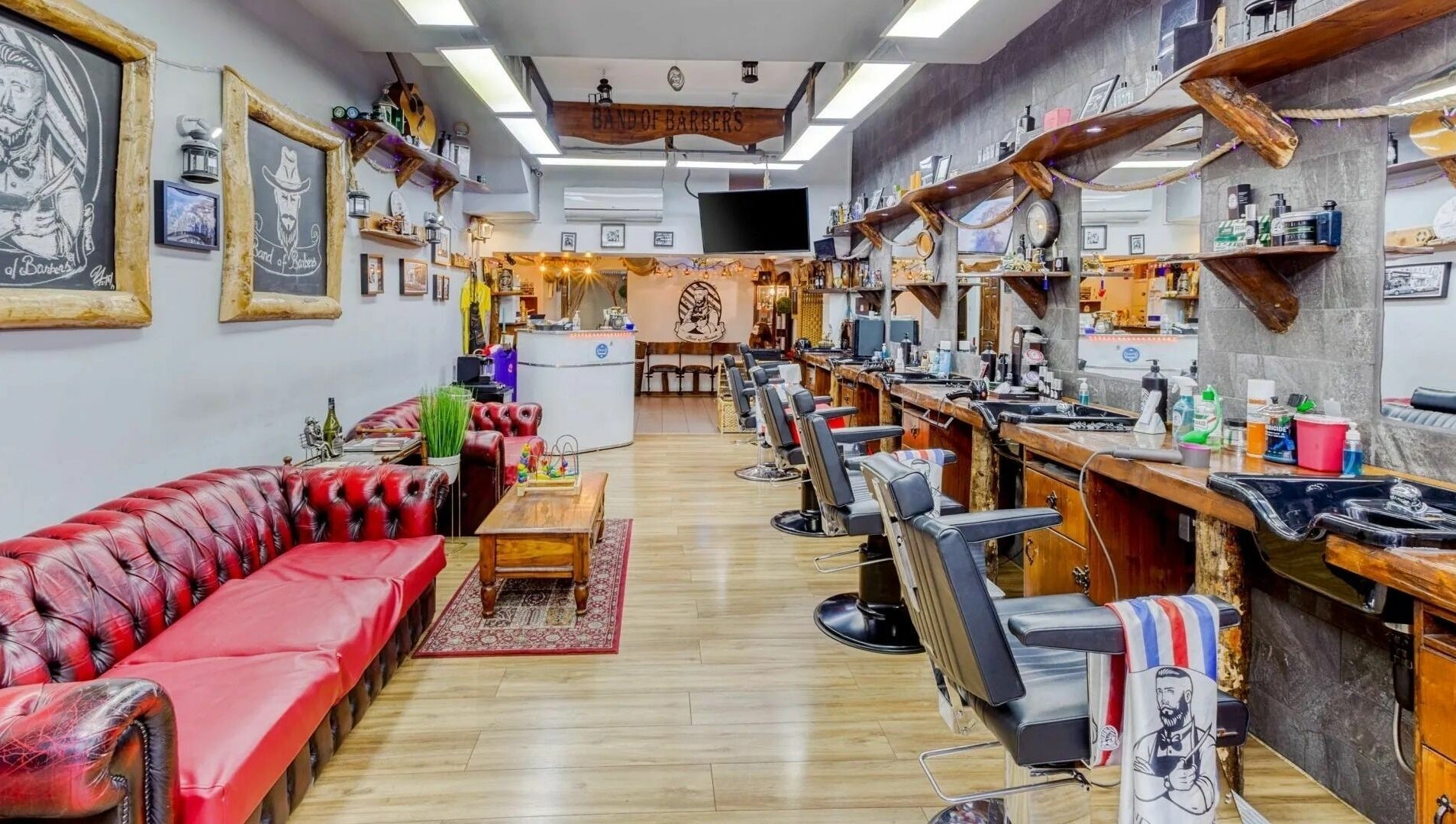 Interior of Band of Barbers VIP Fulham in London, England, GB, showcasing vintage decor and seating.