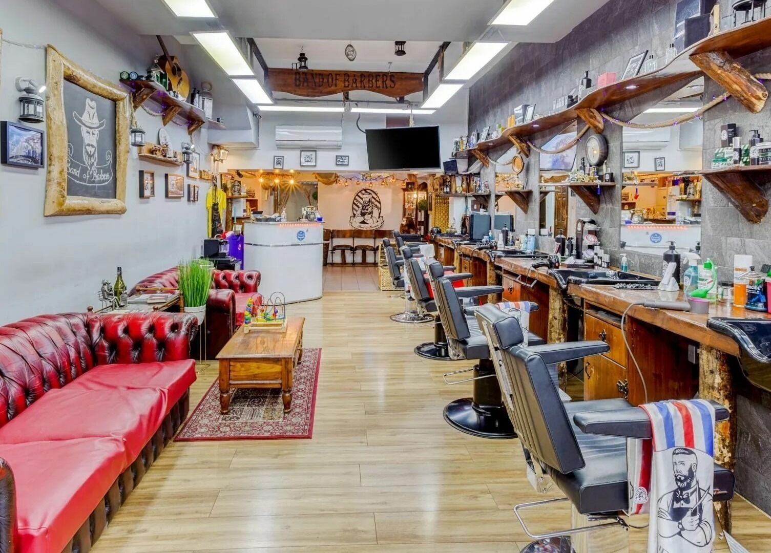 Interior of Band of Barbers VIP Fulham in London, England, GB, showcasing vintage decor and seating.