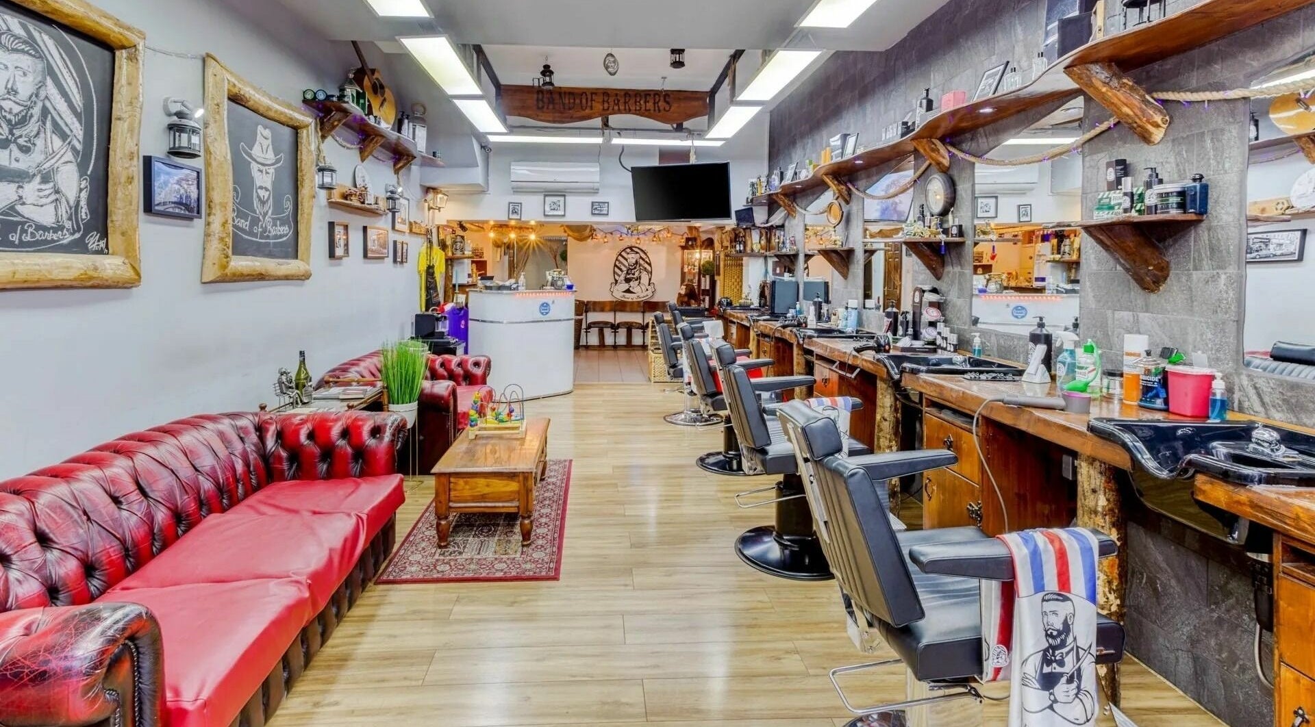 Interior of Band of Barbers VIP Fulham in London, England, GB, showcasing vintage decor and seating.