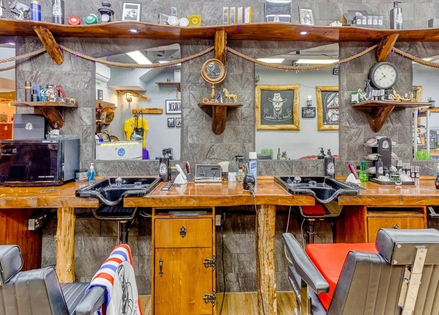 Interior of Band of Barbers VIP Fulham in London, England, GB, featuring rustic barber stations and classic decor.