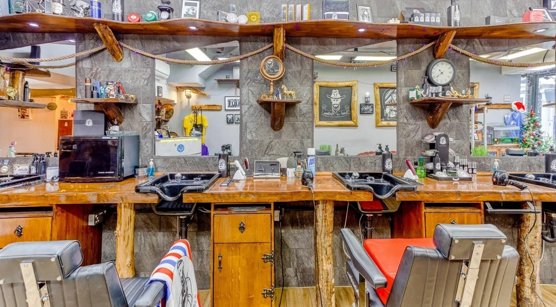 Interior of Band of Barbers VIP Fulham in London, England, GB, featuring rustic barber stations and classic decor.