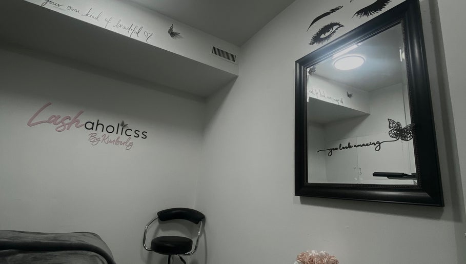 Lashaholicss beauty nook with stylish decor in Toronto, Ontario, CA. Modern mirror and accent chair create a serene space.