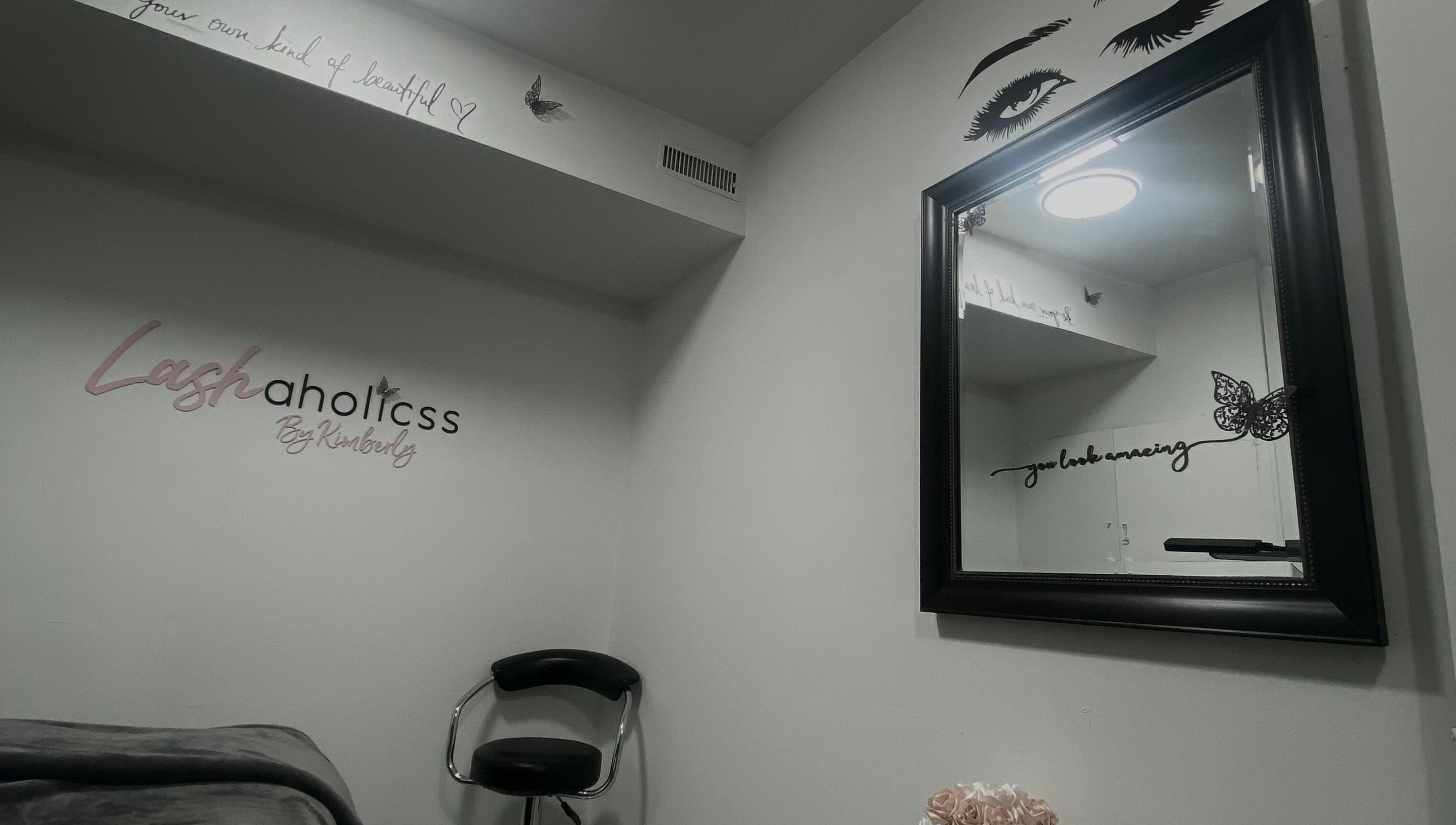 Lashaholicss beauty nook with stylish decor in Toronto, Ontario, CA. Modern mirror and accent chair create a serene space.