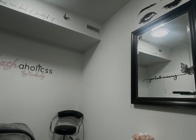 Lashaholicss beauty nook with stylish decor in Toronto, Ontario, CA. Modern mirror and accent chair create a serene space.