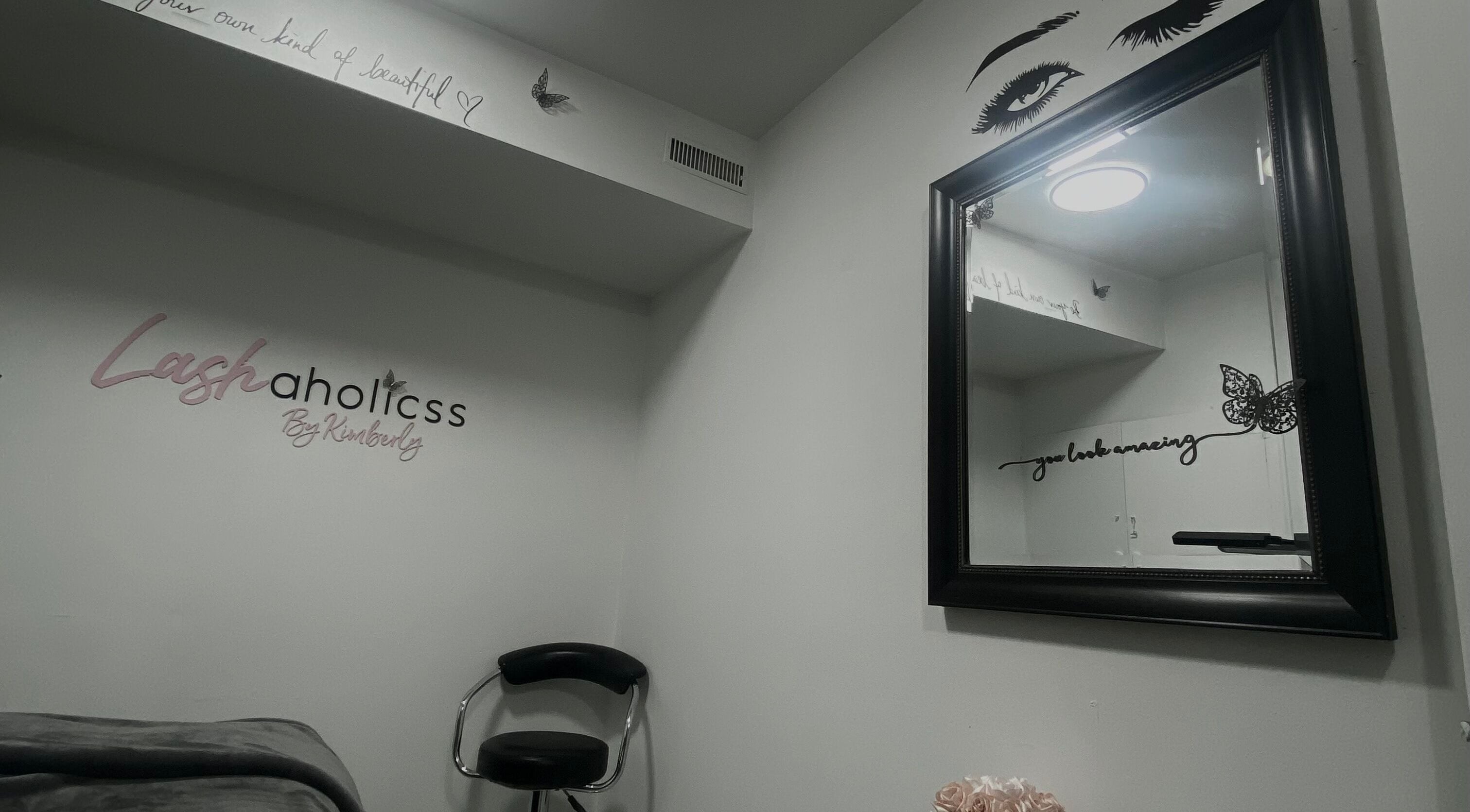 Lashaholicss beauty nook with stylish decor in Toronto, Ontario, CA. Modern mirror and accent chair create a serene space.