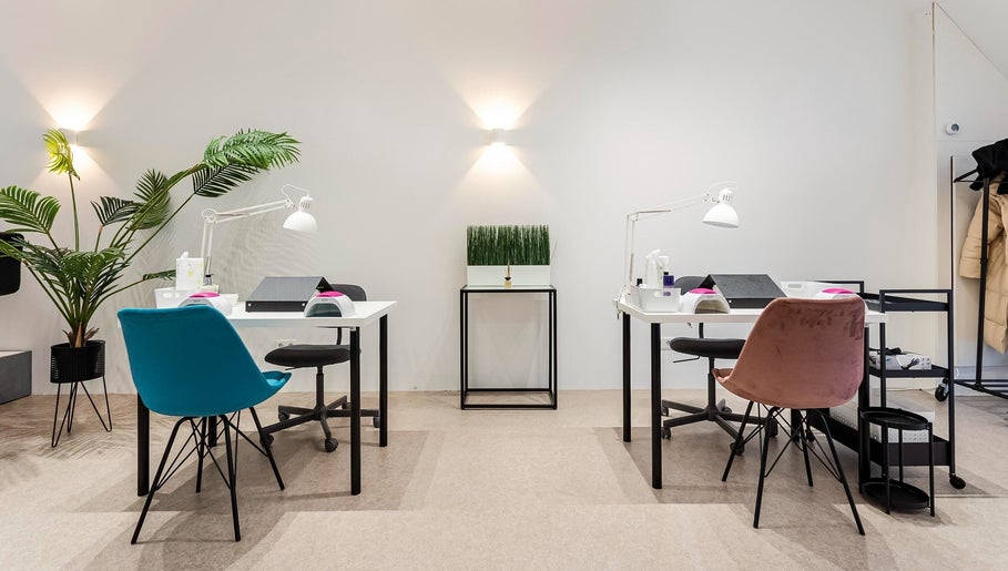 Modern nail station at Endorphine Amsterdam, Amsterdam, Noord-Holland, NL, with stylish chairs and bright lighting.