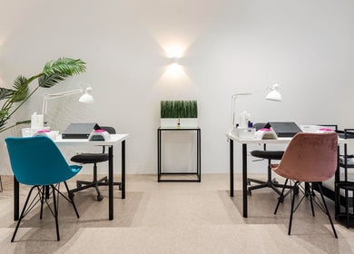 Modern nail station at Endorphine Amsterdam, Amsterdam, Noord-Holland, NL, with stylish chairs and bright lighting.