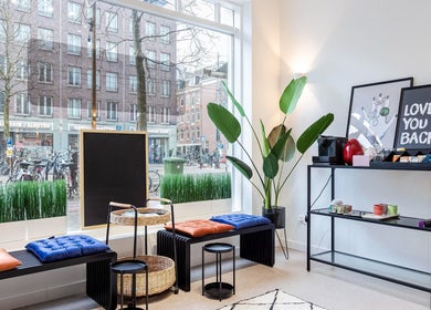 Cozy waiting area at Endorphine Amsterdam with chic decor and large windows, Noord-Holland, NL.