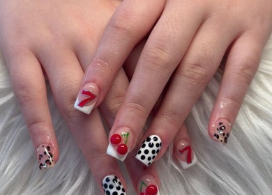 Vibrant nail art with cherries and dots at Lushious Luxuries, Belfast, Northern Ireland, GB.