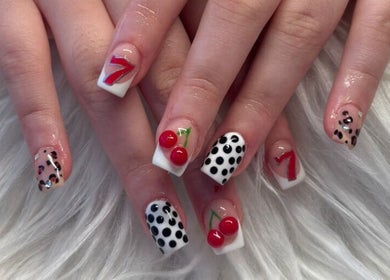 Eye-catching nail art with cherries and polka dots at Lushious Luxuries, Belfast, Northern Ireland, GB.