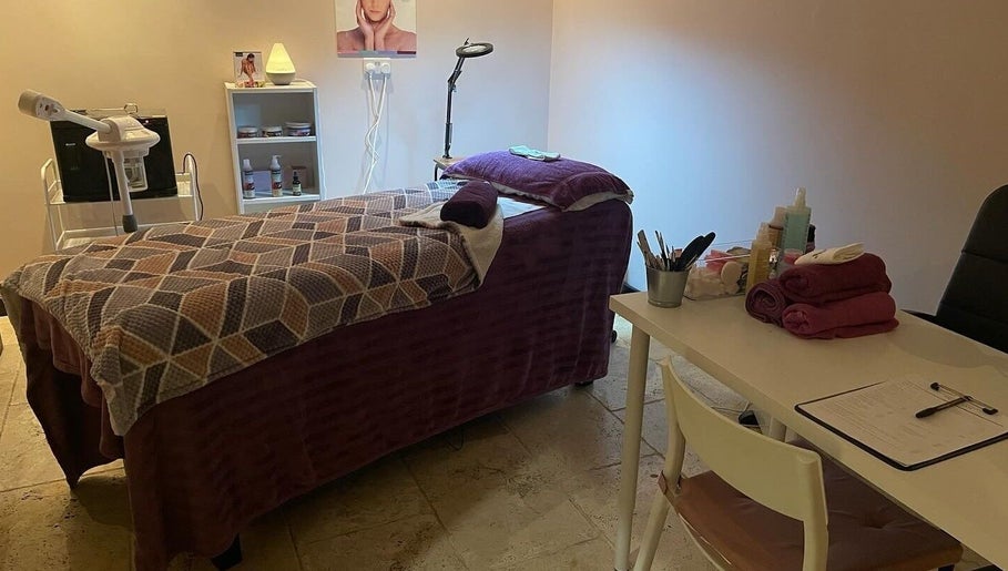 Tranquil treatment room at Lushious Luxuries in Belfast, Northern Ireland, GB, featuring a massage table and beauty tools.