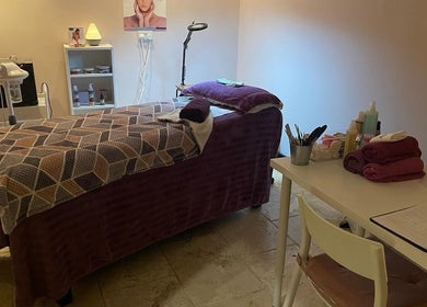 Tranquil treatment room at Lushious Luxuries in Belfast, Northern Ireland, GB, featuring a massage table and beauty tools.