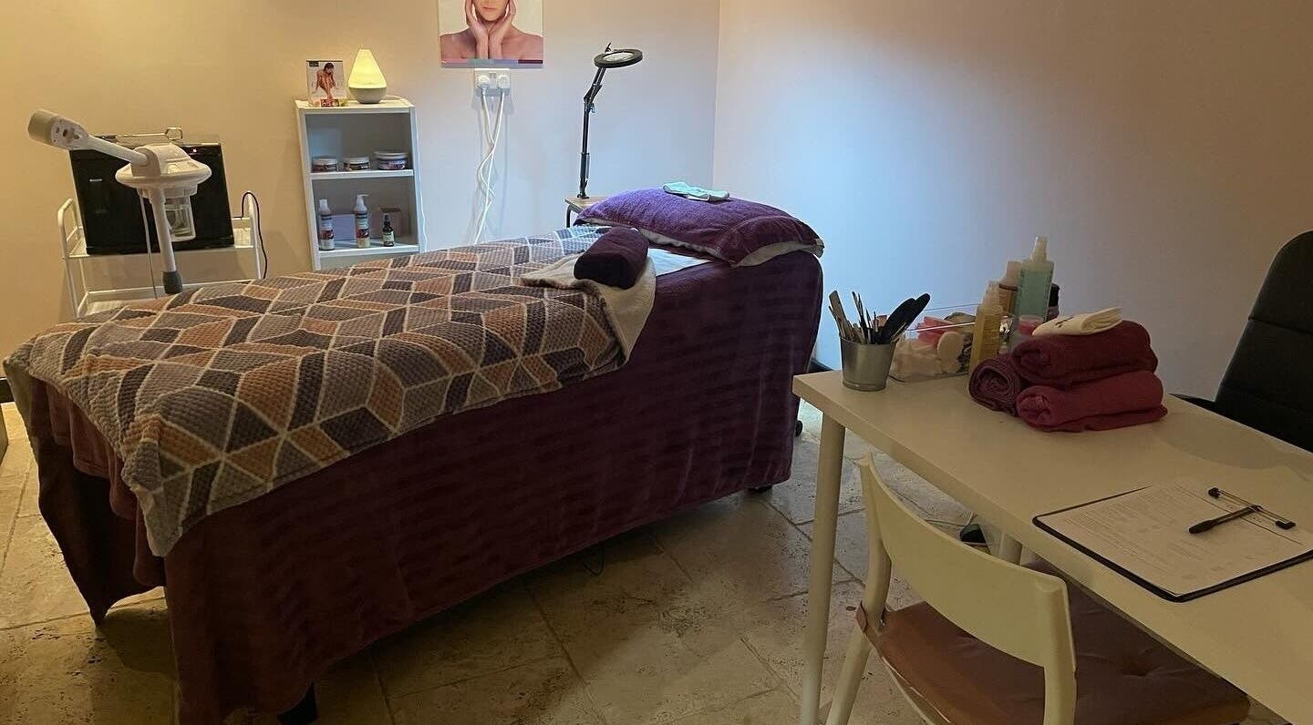 Tranquil treatment room at Lushious Luxuries in Belfast, Northern Ireland, GB, featuring a massage table and beauty tools.
