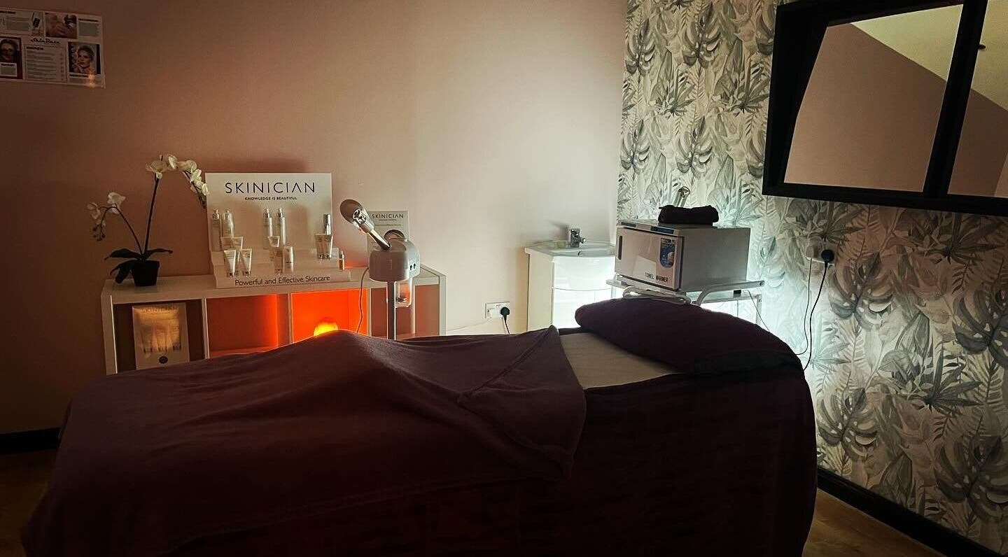 Cozy treatment room at Lushious Luxuries Day Spa, Belfast, Northern Ireland, GB, featuring a skincare display.