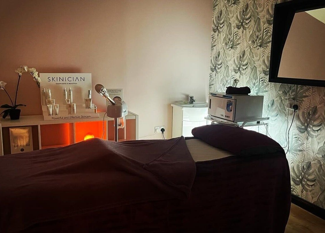 Tranquil treatment room at Lushious Luxuries Day Spa, Belfast, Northern Ireland, GB, with deluxe skincare display.
