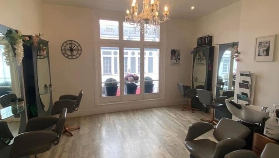 Chic interior of Hollie’s salon on Beresford Street, Jersey, GB with stylish chairs and mirrors.