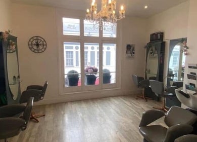 Chic interior of Hollie’s salon on Beresford Street, Jersey, GB with stylish chairs and mirrors.