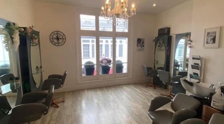 Chic interior of Hollie’s salon on Beresford Street, Jersey, GB with stylish chairs and mirrors.