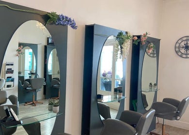 Elegant salon setup at Hollie’s on Beresford Street, Jersey, GB with chairs and mirrors.