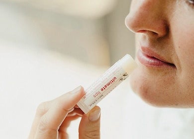 Close-up of lips applying balm at Britta Hansen Skin + Beauty Neutral Bay, Neutral Bay, New South Wales, AU.