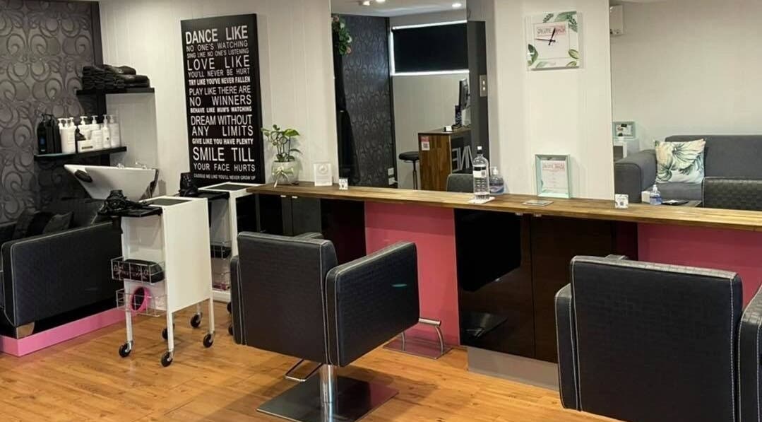 Stylish interior of Dvine Hair by Kelly in Belair, South Australia, AU showcasing modern chairs and decor.