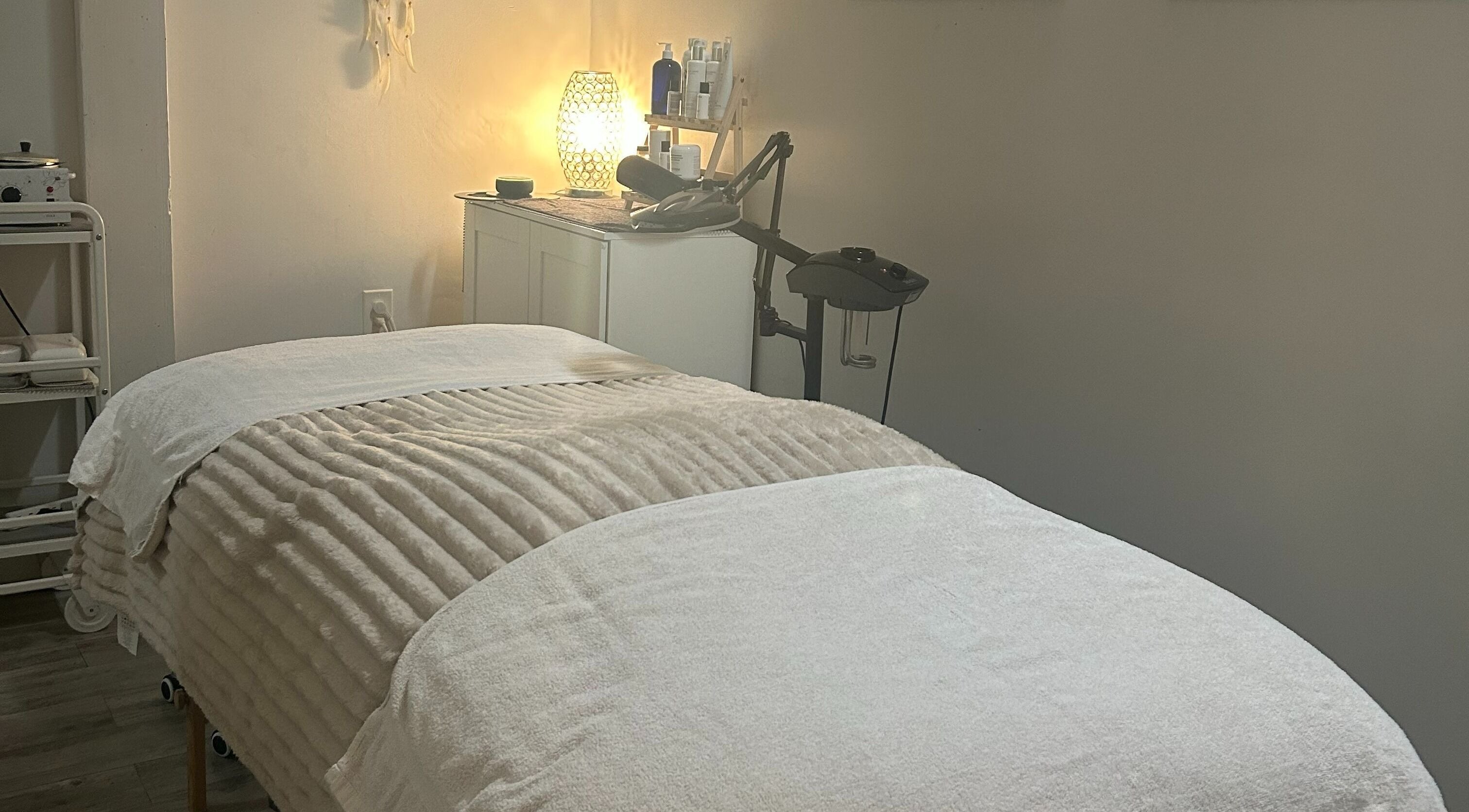 Relaxing treatment room at Elisha Marie Skin & Body, Palo Alto, California, US with a cozy massage table.