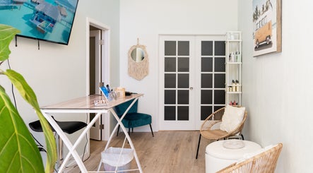 Inviting seating area at Elisha Marie Skin & Body, Palo Alto, California, US with wicker chairs and modern decor.