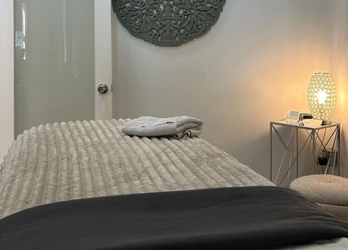 Relaxing treatment room at Elisha Marie Skin & Body, Palo Alto, California, US, adorned with soft lighting.
