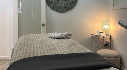 Relaxing treatment room at Elisha Marie Skin & Body, Palo Alto, California, US, adorned with soft lighting.