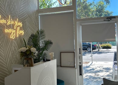 Welcoming entrance at Elisha Marie Skin & Body, Palo Alto, California, US with glowing wall sign and decor.