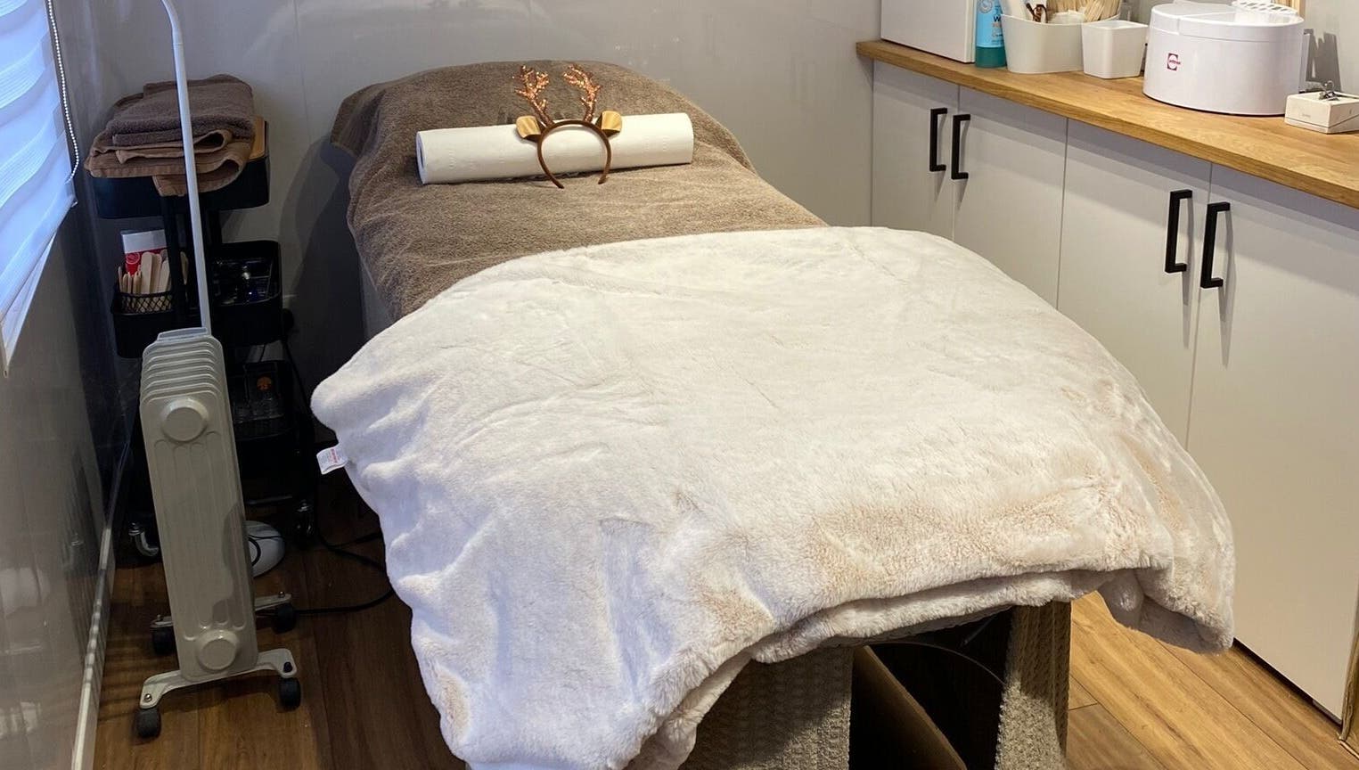 Relaxing treatment room with massage bed at The Beauty Cabin, Swadlincote, England, GB.