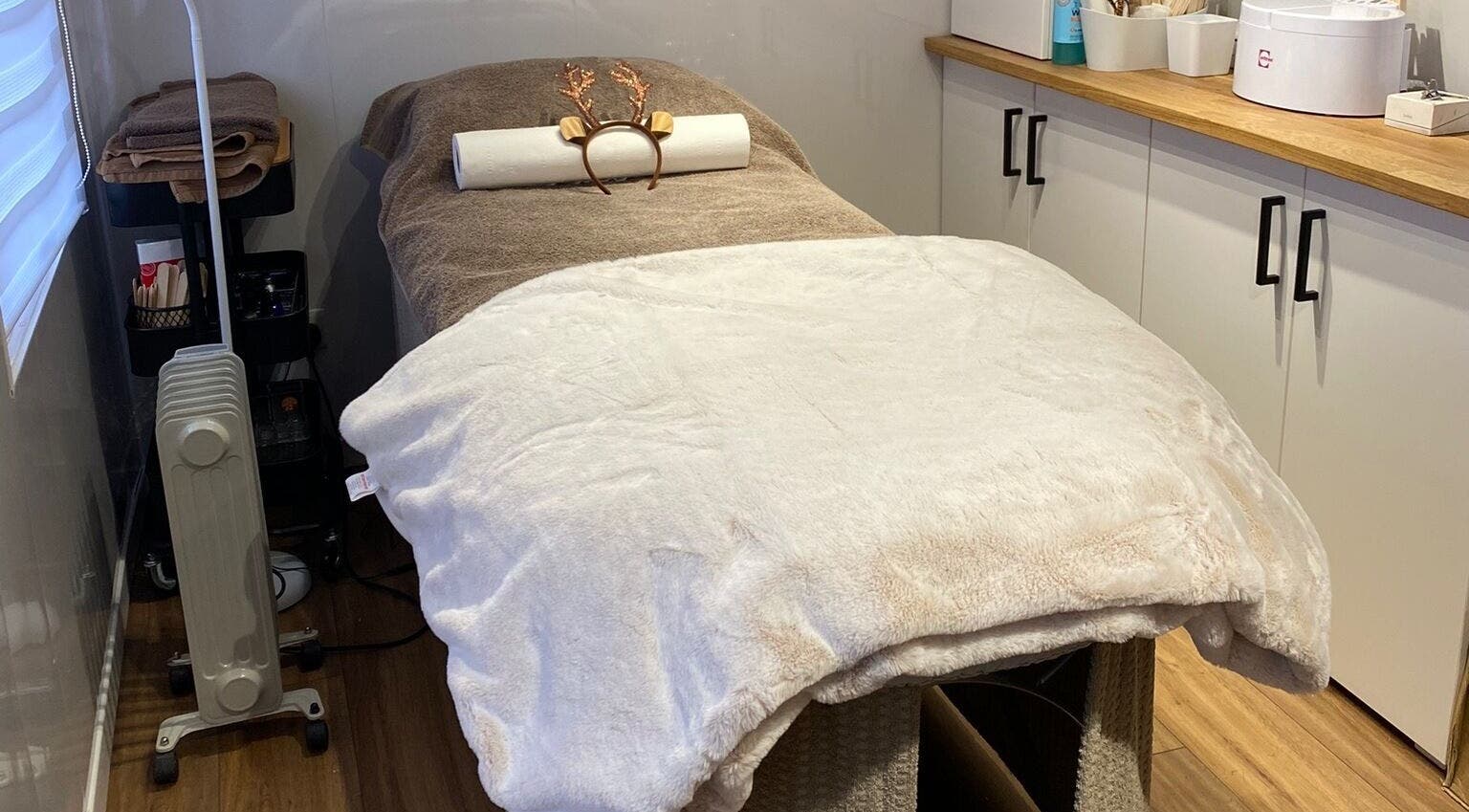Relaxing treatment room with massage bed at The Beauty Cabin, Swadlincote, England, GB.