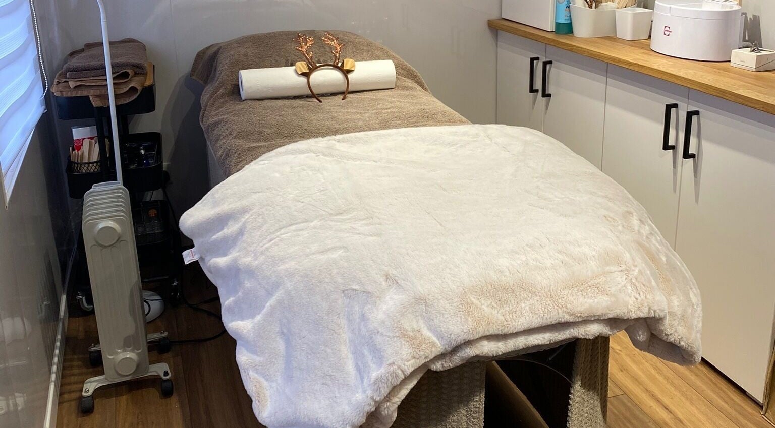 Relaxing treatment room with massage bed at The Beauty Cabin, Swadlincote, England, GB.
