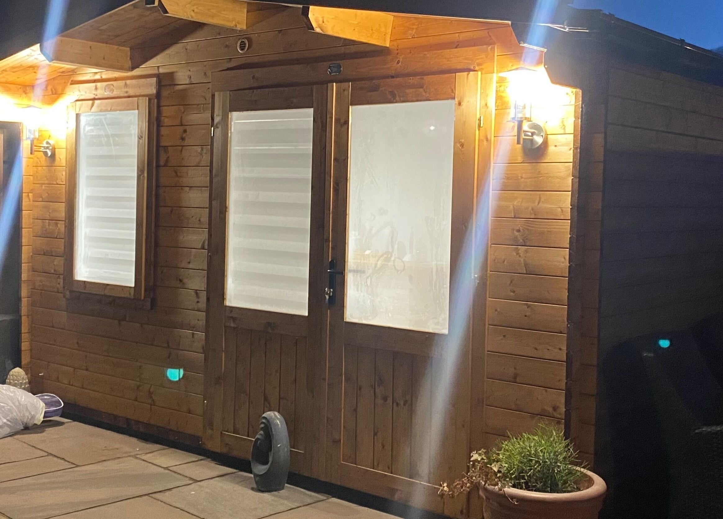 Exterior of The Beauty Cabin lit warmly at night, located in Swadlincote, England, GB.