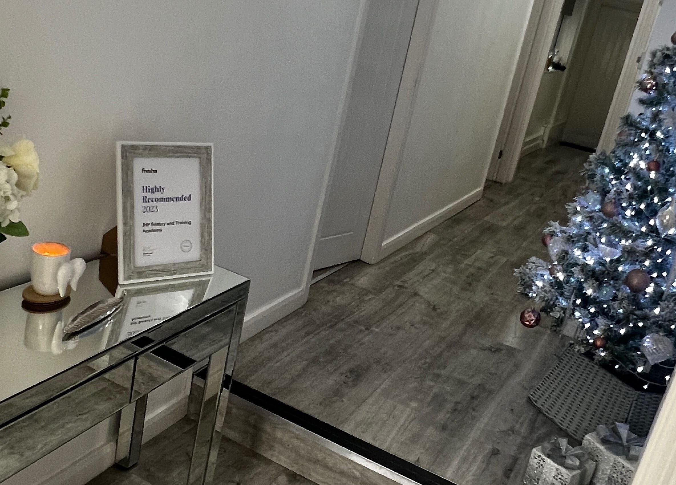 Decorated interior of Salon Twenty9 in Kimberley, England with a Christmas tree and award display.