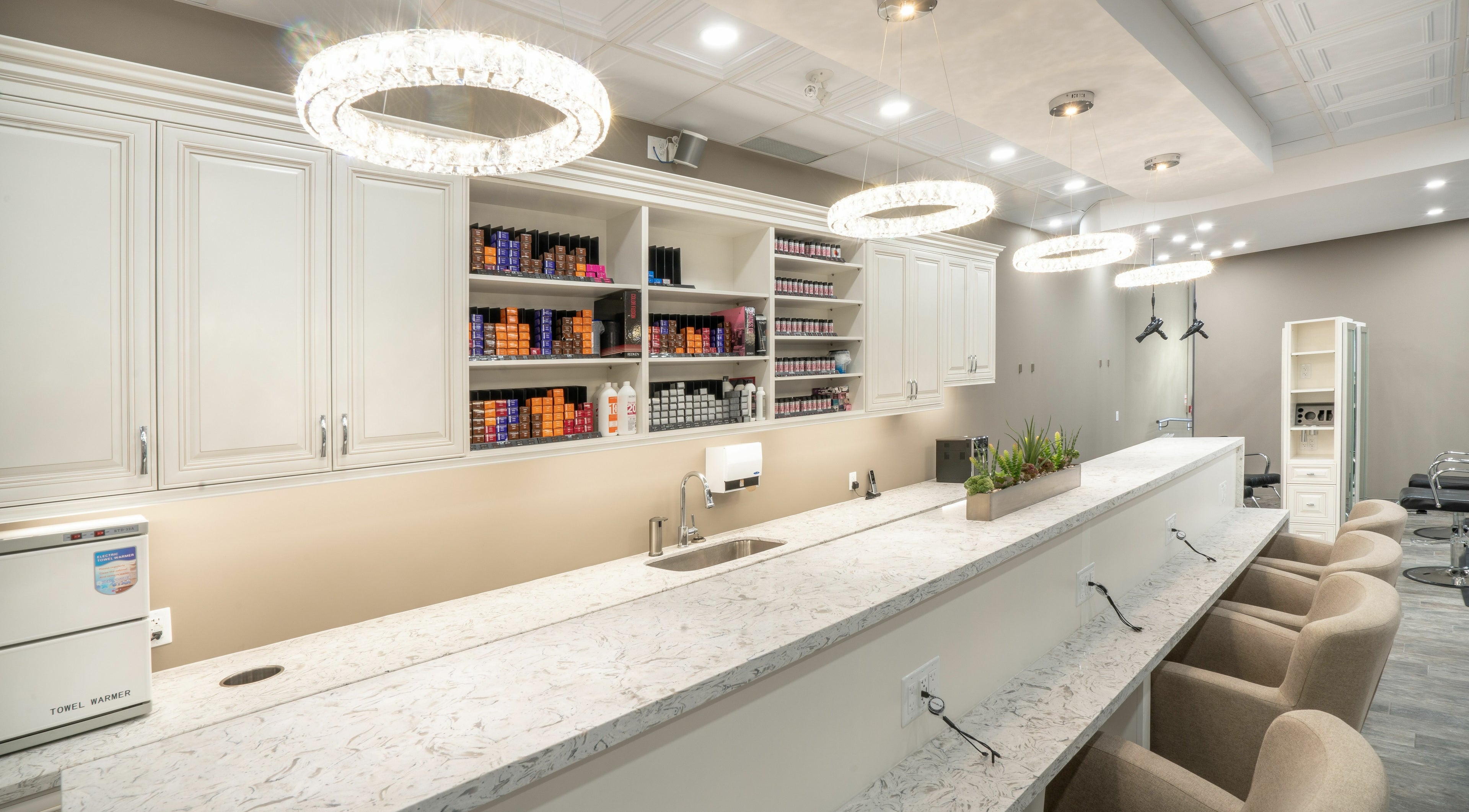 Bright, modern interior of Foiled Salon and Spa in Cambridge, Ontario, CA featuring stylish countertops and seats.