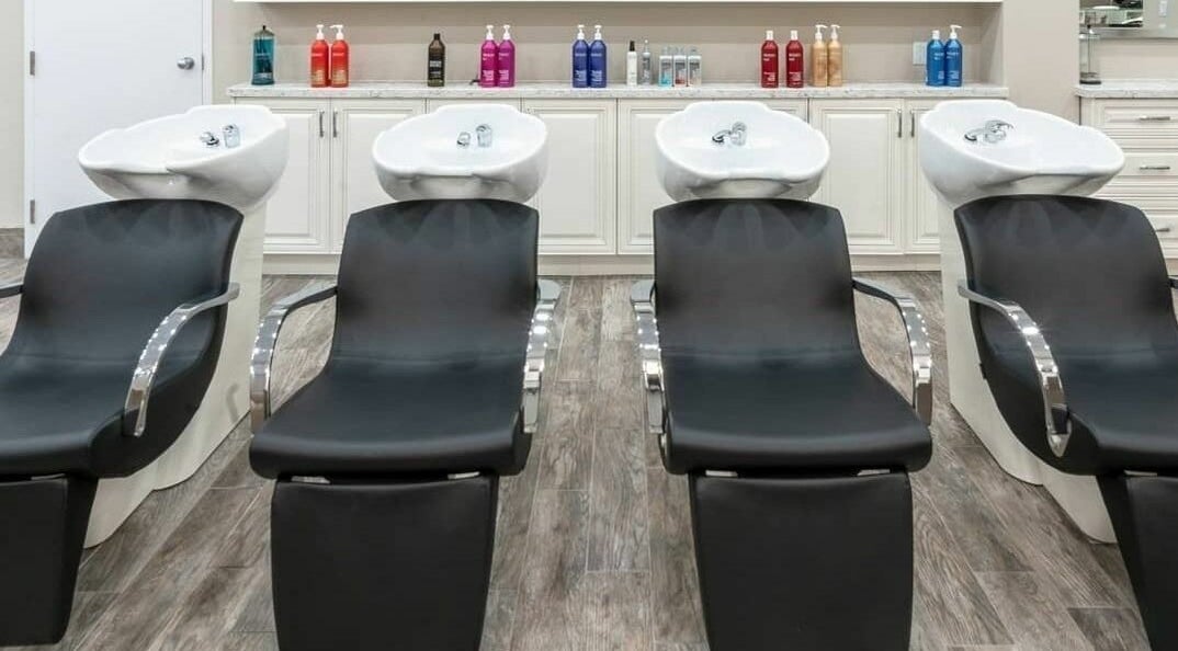 Luxurious shampoo stations at Foiled Salon and Spa in Cambridge, Ontario, CA, offering comfort and style.